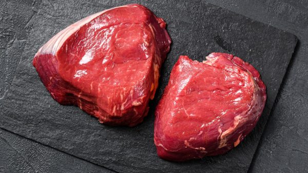 raw steaks fillet Mignon prepared for cooking. Beef tenderloin. Black background. Top view.